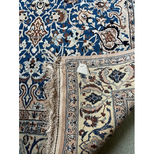 1099 - Hand knotted silk Persian rug. 190cm l x 119cm w.