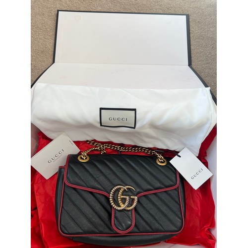 706 - A Gucci Marmont black with red trim and gold coloured chain hand bag, together with original box and... 