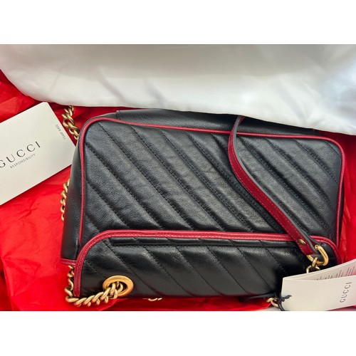 706 - A Gucci Marmont black with red trim and gold coloured chain hand bag, together with original box and... 