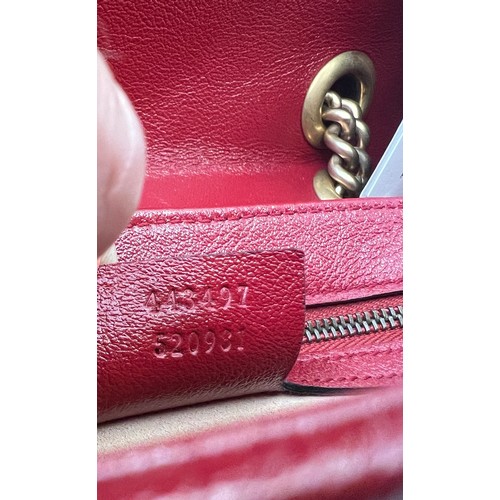 706 - A Gucci Marmont black with red trim and gold coloured chain hand bag, together with original box and... 