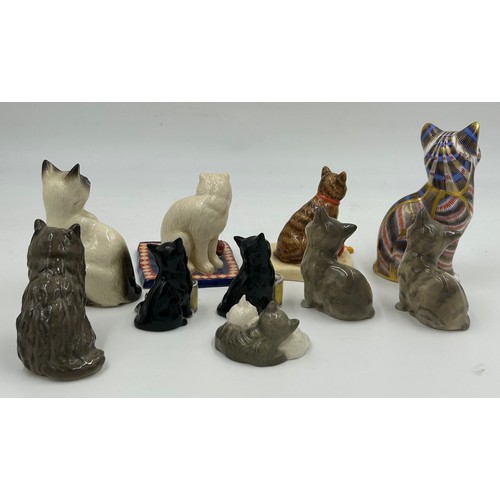 128 - A collection of ceramic cats to include a Royal Crown Derby seated cat with gold stopper (13cm) and ... 