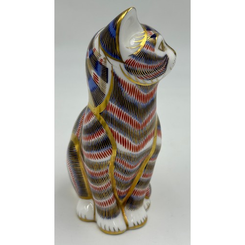 128 - A collection of ceramic cats to include a Royal Crown Derby seated cat with gold stopper (13cm) and ... 