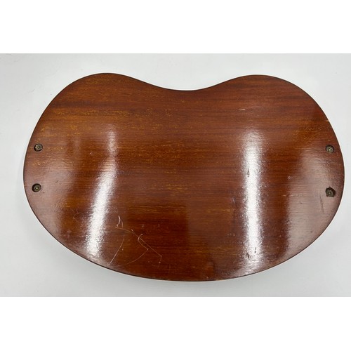 1326 - An Edwardian Mahogany kidney shaped tray with brass handles and shell inlay to centre. 45cm x 28cm.