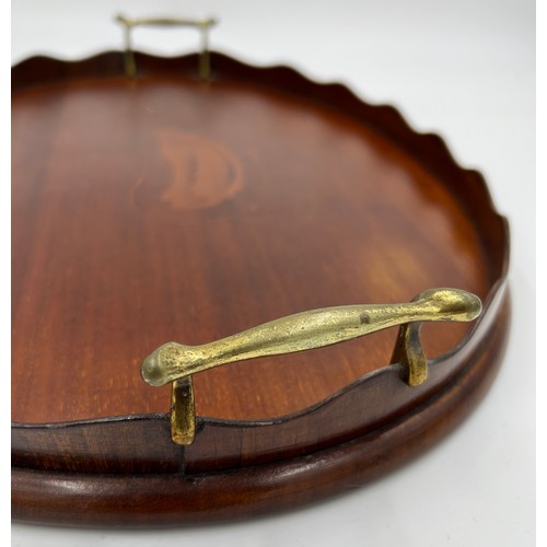 1326 - An Edwardian Mahogany kidney shaped tray with brass handles and shell inlay to centre. 45cm x 28cm.