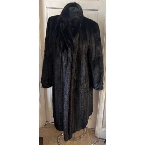 709 - A long length black mink coat.