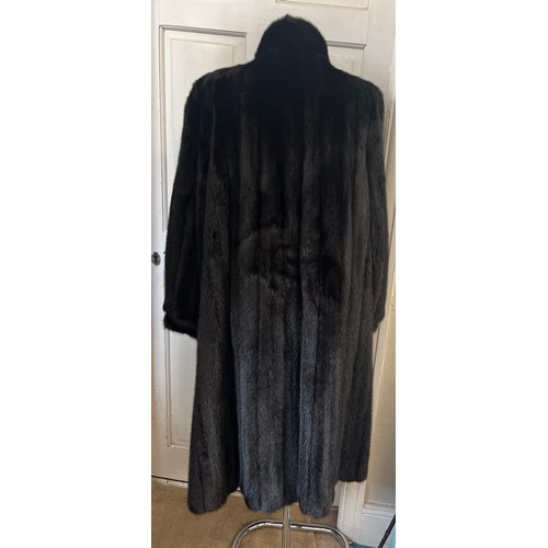 709 - A long length black mink coat.