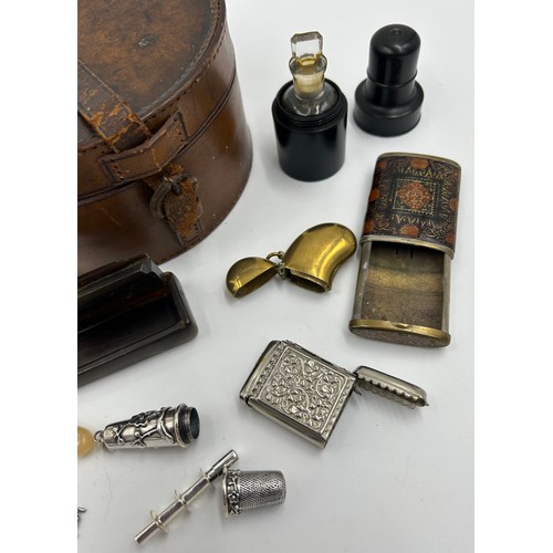 1327 - A miscellany to include : leather collar box, silver plated etui, ebony cased scent bottle, horn snu... 