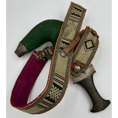 1330 - Arab silver mounted Jambia dagger with horn grip, ribbed curved blade and ornate sheath 31cm.