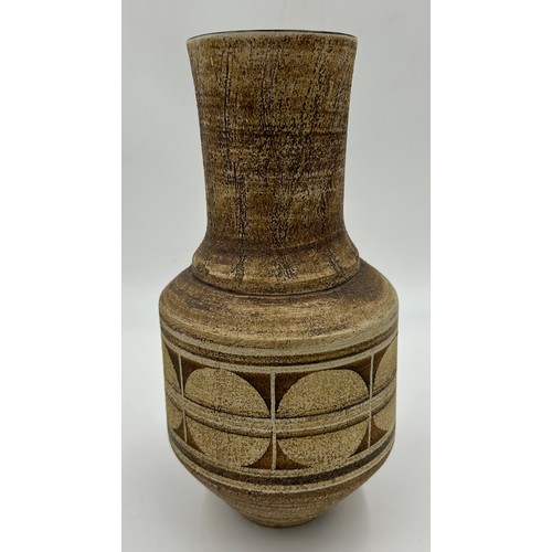 118 - A Troika pottery circular tapered vase with geometric decoration on brown ground marked 'Troika Corn... 