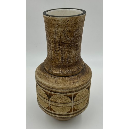 118 - A Troika pottery circular tapered vase with geometric decoration on brown ground marked 'Troika Corn... 