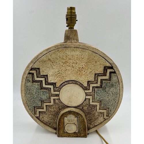 119 - A large Troika Wheel lamp base with abstract relief designs to both sides, brown green and cream col... 