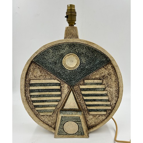 119 - A large Troika Wheel lamp base with abstract relief designs to both sides, brown green and cream col... 