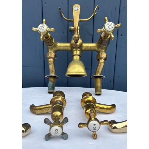 416 - A quantity of brass items to include T.A. Harris Ltd, London bath & shower tap, 2 sets of taps and v... 