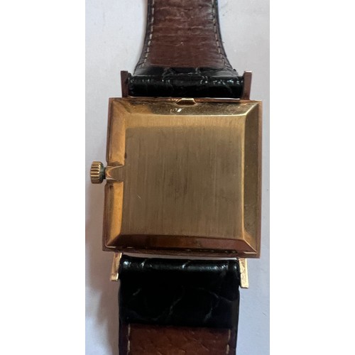 797 - A 9ct gold gentleman's Omega De Ville wristwatch on black leather strap and cream coloured square fa... 