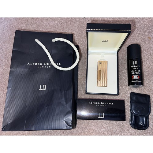 1338 - A gold plated Dunhill lighter together with Dunhill matches, butane gas, bad and leather pouch.