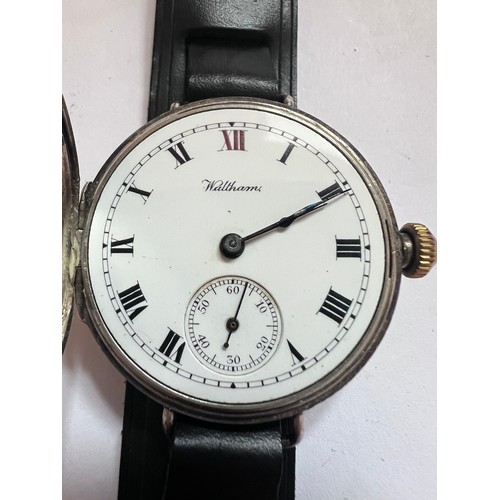 785 - A silver cased half-hunter Waltham wristwatch, with blue enamelled Roman numerals to front case. Dat... 