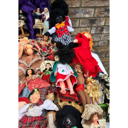 1196 - A quantity of mainly foreign/ tourist dolls to include knitted, wooden and plastic, some hand crafte... 