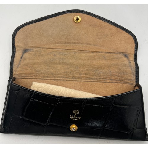 697 - A black leather Mulberry glasses case 17cm x 7cm together with a black leather telephone case 12cm x... 