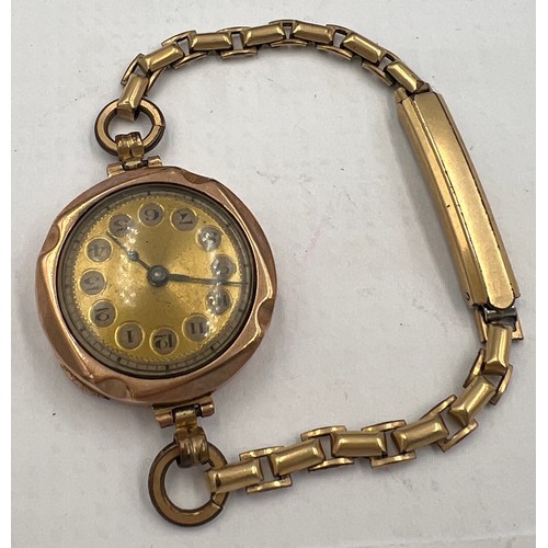 773 - A 9 carat gold cased ladies wristwatch on rolled gold strap. Total weight 19.1gm.