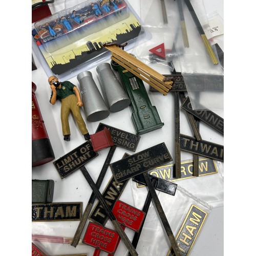 1228 - A collection of various miniature railway accessories to include model train metal railway signs, un... 