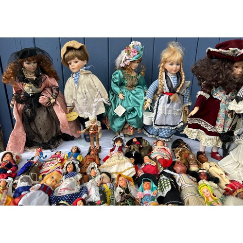 1208 - A collection of various dolls to include vintage tourist dolls, Corolle, Leonardo etc together with ... 