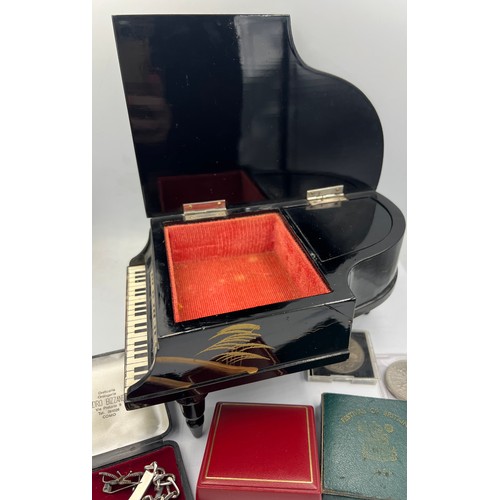 1350 - A miscellaneous lot to include grand piano black lacquer music box, crowns, silver identity bracelet... 