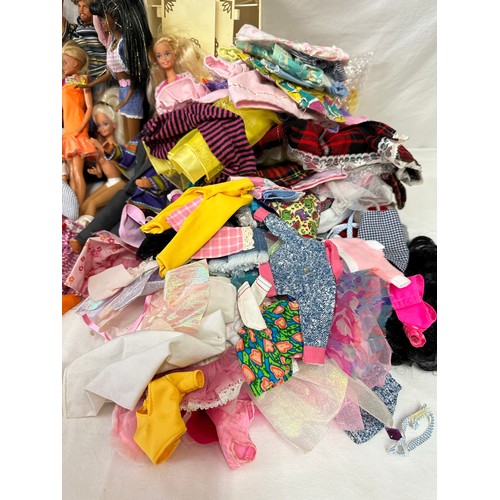 1201 - A mixed collection comprising of Barbies, Ken's and GI Joe along with some original Barbie clothes a... 