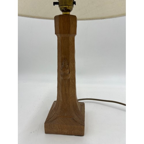 72 - Robert 'Mouseman' Thompson. An English oak table lamp with an octagonal column on a square base with... 