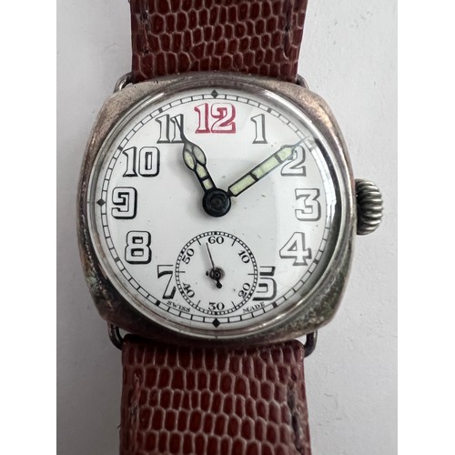 770 - A 1910'a gentleman's silver cased wristwatch on brown leather strap and subsidiary seconds dial with... 