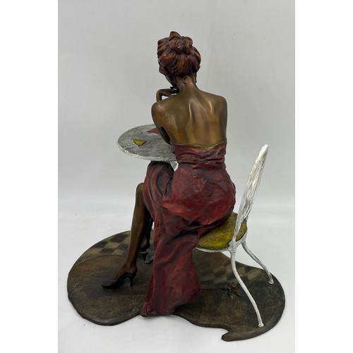 1353 - A heavy bronze Isaac Maimon sculpture ‘Anna’ A lady dressed in red seated at a table. 40cm h.