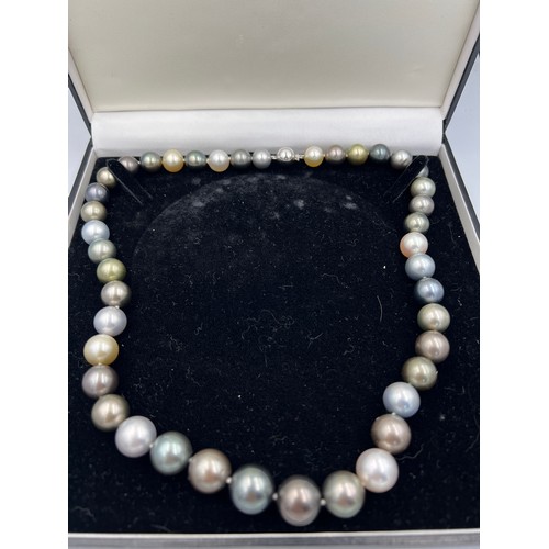 689 - A Tahiti and south sea pearl necklace of natural colour. 42 pearls in total. 18 carat white gold bal... 