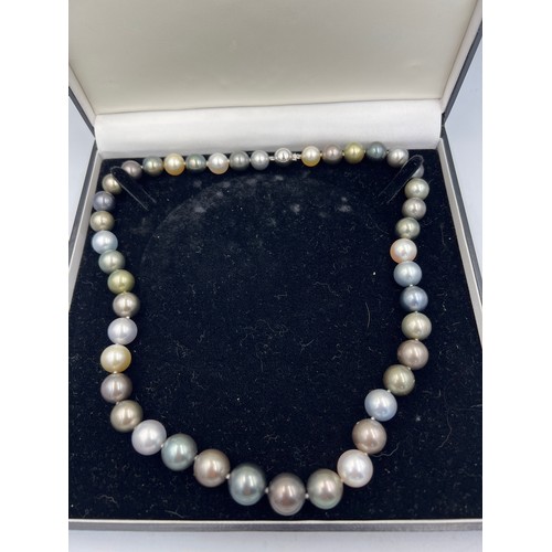 689 - A Tahiti and south sea pearl necklace of natural colour. 42 pearls in total. 18 carat white gold bal... 