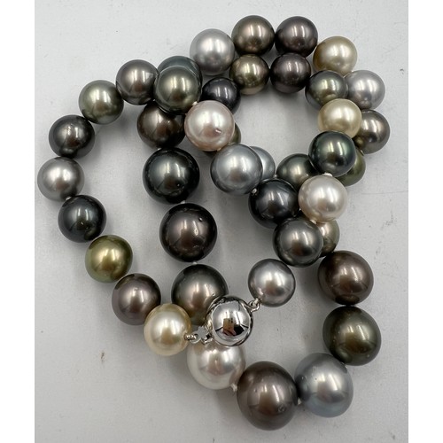 689 - A Tahiti and south sea pearl necklace of natural colour. 42 pearls in total. 18 carat white gold bal... 