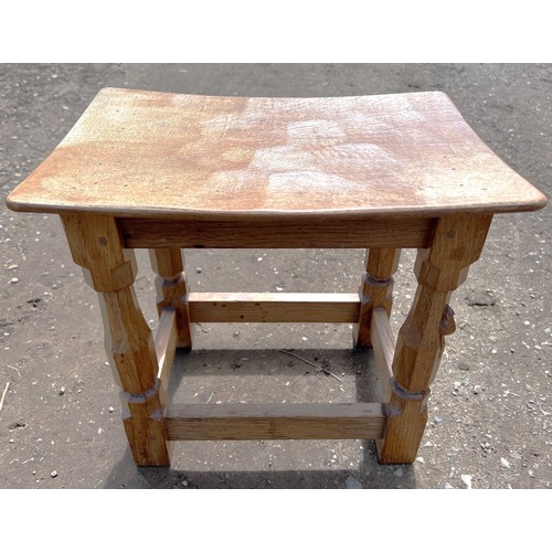 70 - An oak Robert 'Mouseman' Thompson stool with adzed top. 40cm w x 27.5cm d x 31cm h.