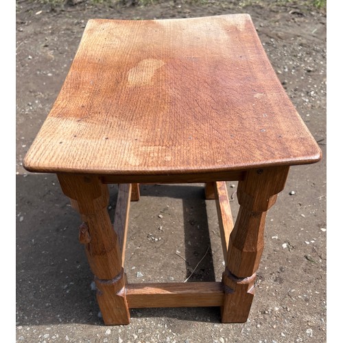 70 - An oak Robert 'Mouseman' Thompson stool with adzed top. 40cm w x 27.5cm d x 31cm h.