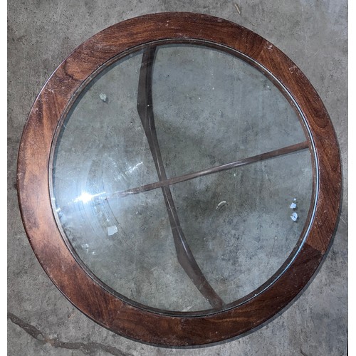 5 - A mid 20thC G Plan circular rosewood table with glass top. 84cm d x 46cm h.