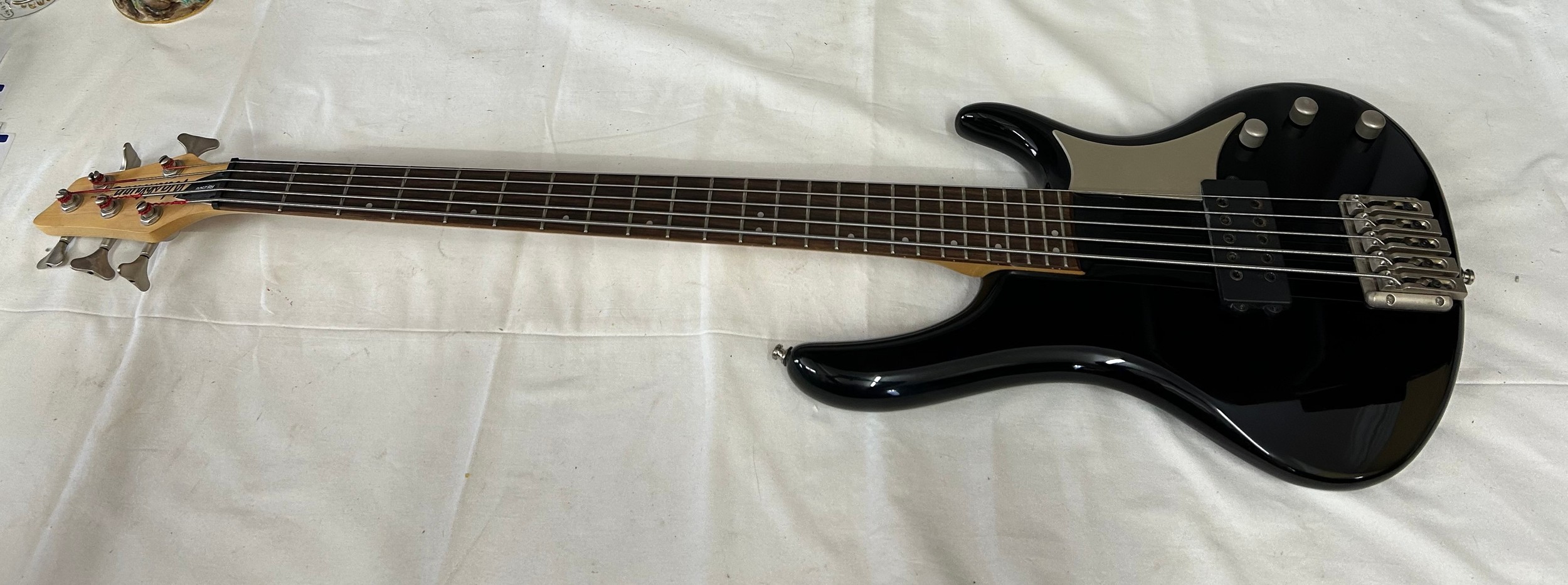 A Washburn Bantam RB-2500 5-string active electric bass guitar.