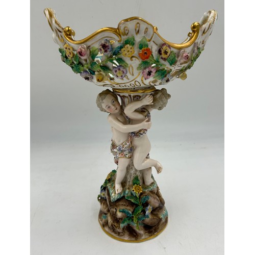 95 - A Meissen table centrepiece with a pierced twin-handled basket, a supporting column with two putti o... 