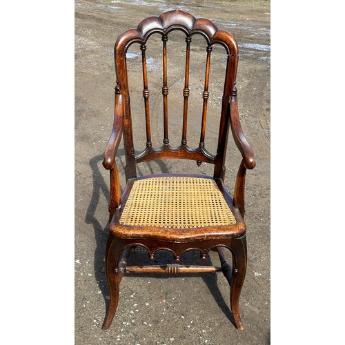 62 - A 19thC cane seated armchair with front cabriole legs and scroll arms. 108cm to back, 43cm to seat.