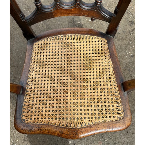 62 - A 19thC cane seated armchair with front cabriole legs and scroll arms. 108cm to back, 43cm to seat.