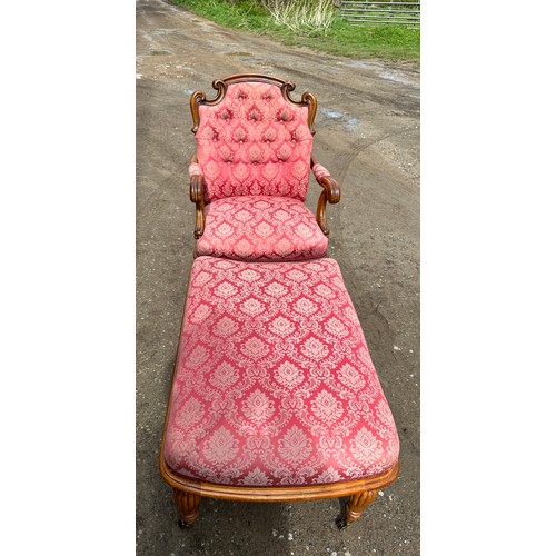 63 - An upholstered armchair with turned reeded legs and brass castors together with abutting footstool t... 