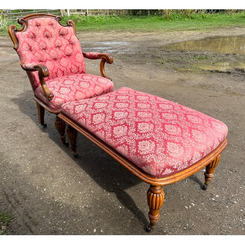 63 - An upholstered armchair with turned reeded legs and brass castors together with abutting footstool t... 