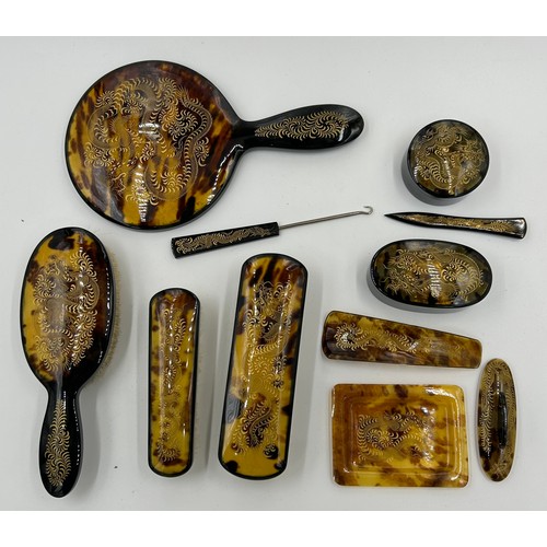 1362 - A Faux tortoiseshell 20thC vanity set with gold engraved dragon decoration in original silk lined ca... 