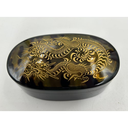 1362 - A Faux tortoiseshell 20thC vanity set with gold engraved dragon decoration in original silk lined ca... 