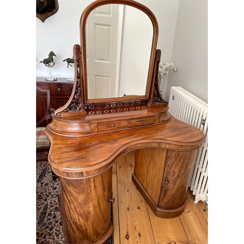 61 - A mahogany pedestal serpentine fronted dressing table with two cupboards to base with mirror back an... 