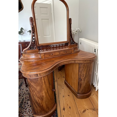 61 - A mahogany pedestal serpentine fronted dressing table with two cupboards to base with mirror back an... 