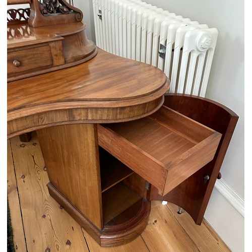 61 - A mahogany pedestal serpentine fronted dressing table with two cupboards to base with mirror back an... 