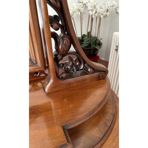 61 - A mahogany pedestal serpentine fronted dressing table with two cupboards to base with mirror back an... 