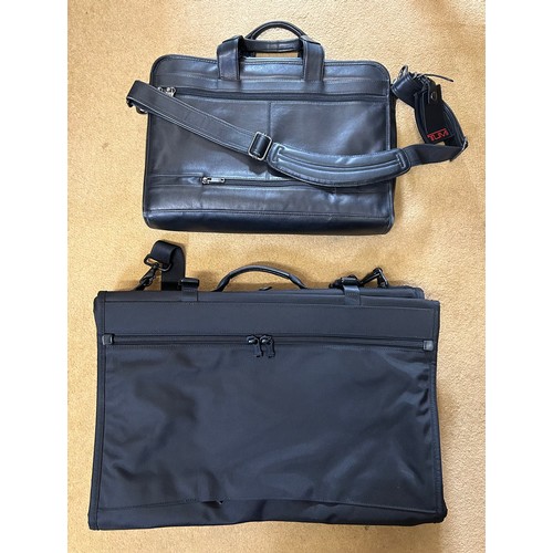 725 - A Tumi black leather briefcase/laptop bag together with a black Tumi suit carrier with leather handl... 