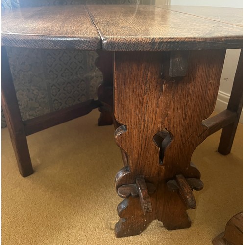 60 - An oak drop leaf circular side table. 91cm x 77cm open x 50cm h. 30cm w when leaves down.